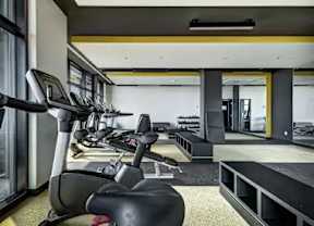 A gym with treadmills and elliptical machines.