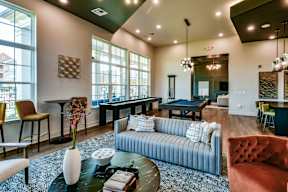 A living room with a pool table and a couch.