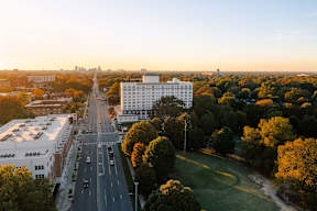 A city street with cars and buildings on either side.