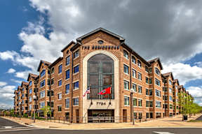 The Residence hotel with a flag on the building.