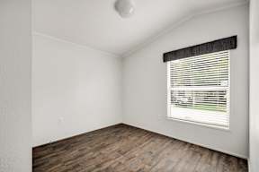 Room with a window and wooden floors at Regency Village, Texas