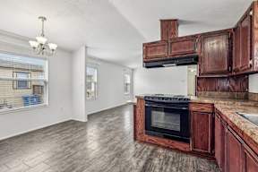 A kitchen with wooden cabinets and a black oven at Country Lane, Cheyenne, Wyoming