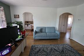a living room with a blue couch and a tv at Country Lane, Wyoming
