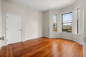 A room with wooden floors and white walls.