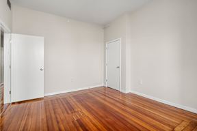 A room with wooden floors and white walls.