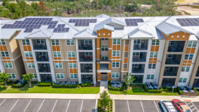 a large apartment building with solar panels on the roof