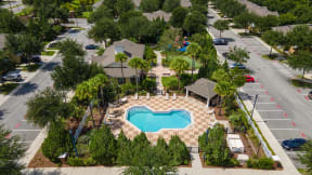 an aerial view of a home with a swimming pool in the front yard