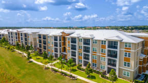 an aerial view of a large apartment complex with a blue sky in the background