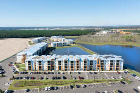an aerial view of a large apartment complex next to a body of water