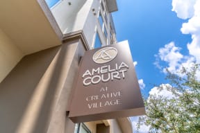 a sign for the amelia court at creative village is shown in front of a blue sky