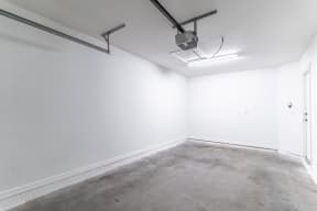 an empty room with white walls and a fluorescent light on the ceiling