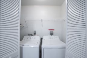 the laundry room has two washers and two dryers