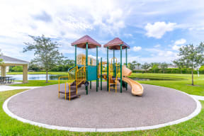 a playground with a slide and monkey bars in the middle of a grassy area
