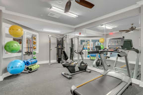 fitness center with equipment and mirror