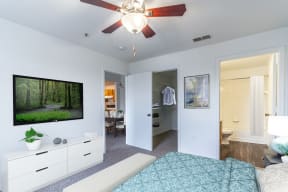 a bedroom with a bed and a ceiling fan