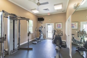 fitness center with equipment and mirror