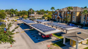 a row of solar panels sits in the middle of a parking lot