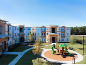 an exterior view of an apartment complex with a playground