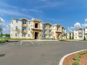 an empty parking lot in front of an apartment complex