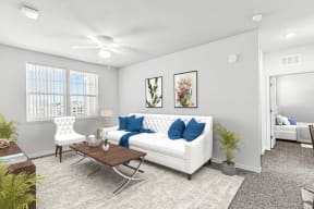 a living room with a white couch and blue pillows