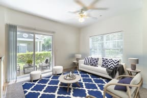 a living room with a white couch and a blue rug