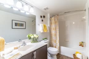 a bathroom with a white toilet next to a tub with a shower curtain