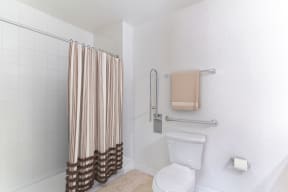 a bathroom with a white toilet next to a shower curtain