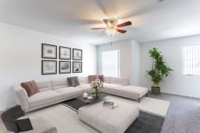 a living room with white walls and a ceiling fan