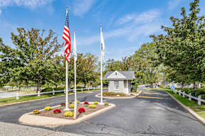 Road with two flags at Four Winds Apartments, Fall River, 02720