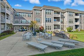A sunny day at the apartment complex with tables and chairs set up for outdoor dining.