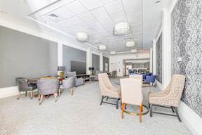 A conference room with a long table and chairs.