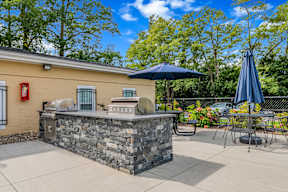 A stone barrier in front of a yellow building.