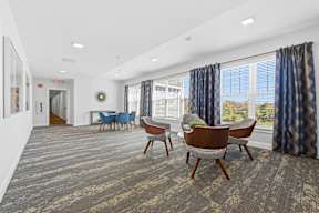 A conference room with a long table and chairs.