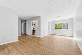 A room with wooden floors and white walls.