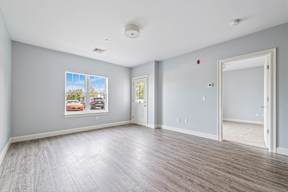 Room with wooden floors at Four Winds Apartments, Fall River, MA