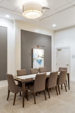 a dining room with a long table and chairs