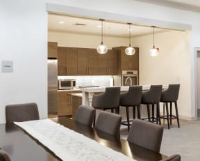 a kitchen and dining room with a long table and chairs