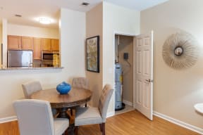 a dining room with a table and chairs and a kitchen
