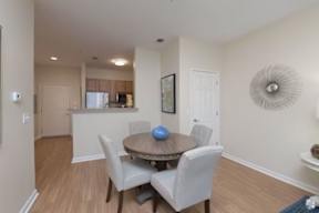 a dining room with a table and chairs