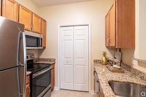 full kitchen with stainless steel appliances and granite counter tops
