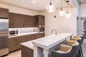 a large kitchen with a white counter top