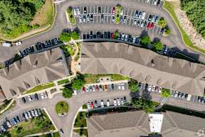 an aerial view of a parking lot with cars parked