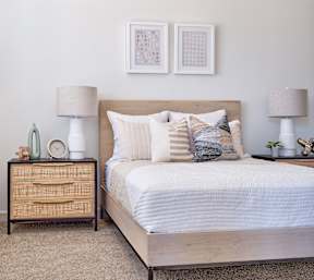 a bedroom with a wooden bed and two lamps