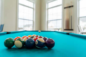 a pool table with a bunch of balls on it