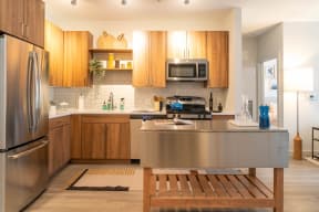 a kitchen with wooden cabinets and stainless steel countertops