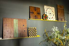 a shelf with a clock and games on it
