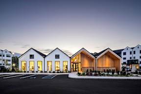 A modern building with a parking lot in front.