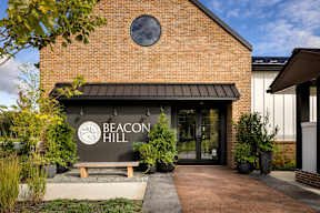 The front of a building with a sign that says Beacon Hill.