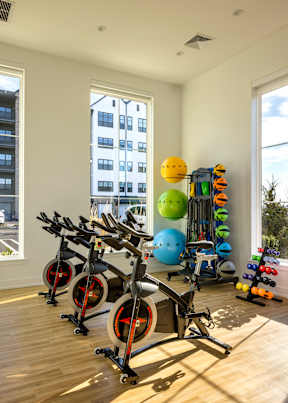 A home gym with exercise equipment and a window view.