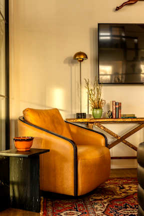 A yellow chair with a small table in front of it.
